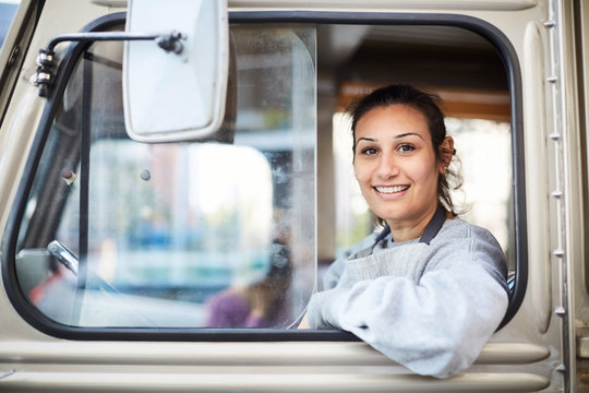 Portrait of woman driving truck