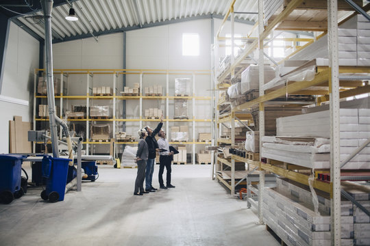 Three people in warehouse