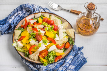 Salad with cheese and fresh vegetables.