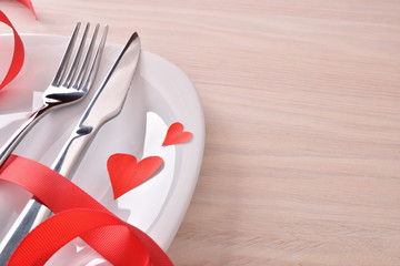 Table decorated with red ornaments for valentines day elevated