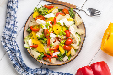 Salad with cheese and fresh vegetables.