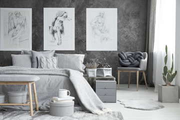 Posters in bright bedroom interior