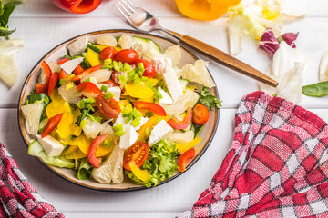 Salad with cheese and fresh vegetables.