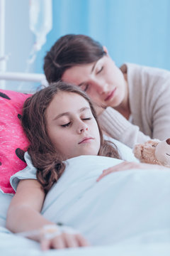 Mother sleeping with sick daughter