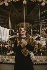 Fototapeta na wymiar Young woman in the carousel of Paris