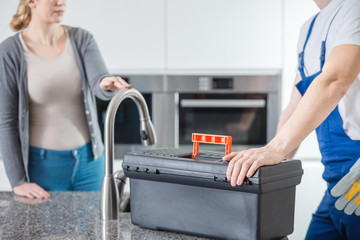 Sanitation technician with black toolbox