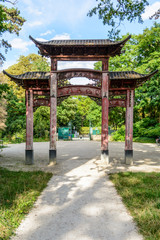 Rear view of the old wooden chinese gateway standing at the main entrance of the garden of tropical agronomy in Paris.