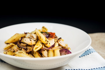 Pasta with pesto sauce and nuts on a the table