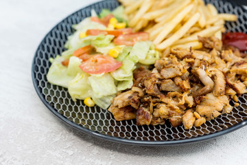 Fresh chicken steak with tomatoes and french fries