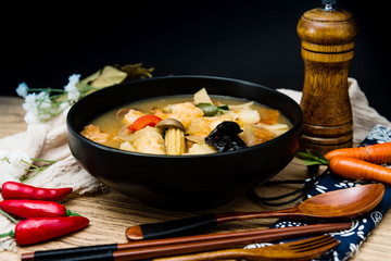 Bowls of Asian soup noodles and vegetables with Chopstick