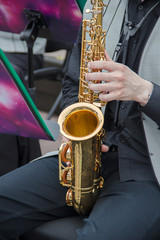 Saxophonists playing in a jazz band, dressed in men's classic vest and trousers. Shoot from above