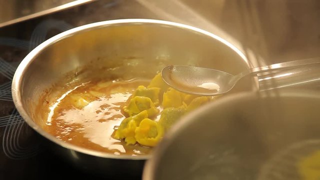 chef coooking ravioli agnolotti with sauce
