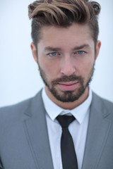 Serious businessman wearing suit and tie. blue background