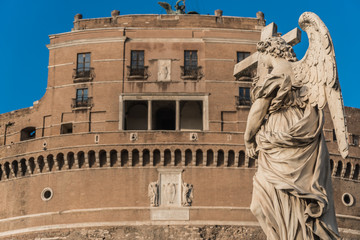 Statue of angel with cross, Saint Angelo castle on background