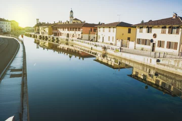 Deurstickers Naviglio Grande canal waterway passes near the historic and colorful buildings of Gaggiano (Milan, Italy) © Arcansél