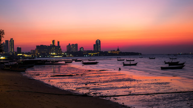 PATTAYA, THAILAND - January 14 - 2018: Fishing boats at coastal in sunset. The back of Pattaya city.