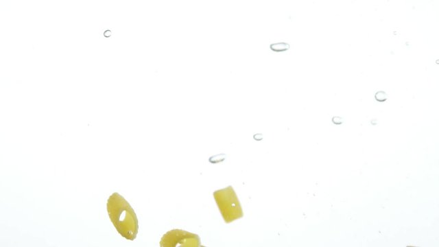 penne pasta dropping in boiling water