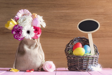 Flowers and Easter basket with a banner - Bouquet of flowers in a jute sack and a wicker basket...