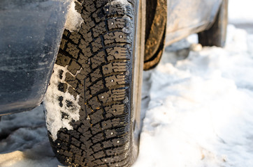 winter tires with spikes in snow