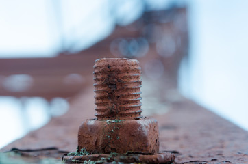 Corrosive rusted bolt with nut. Grunge industrial construction