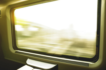 Traveling by train: look out the window at a moving landscape at sunset