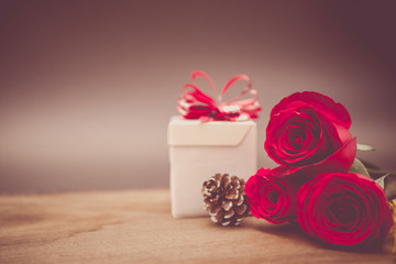 Valentines Day Background with Gift Box and Red Rose on Wood Table Rustic style