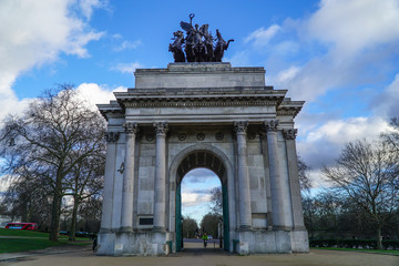 Wellington Arch or Constitution Arch is a triumphal arch located to the south of Hyde Park in London. Dramatic cloudy sky.