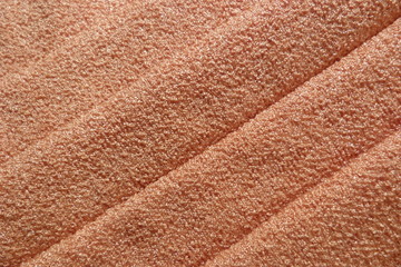 knitted textile fabric close-up of a golden fabric of a juicy orange color orange texture of sand...