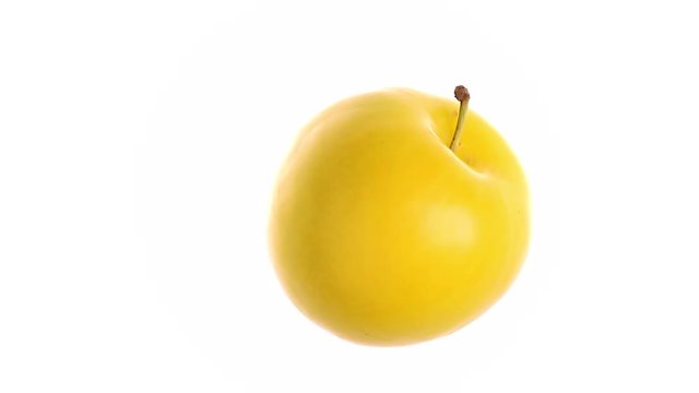 rotating yellow plum on white background
