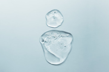 Perfume bottle made from gel and water on a blue background