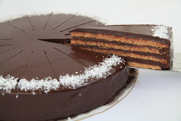 delicious chocolate cake with one piece cut from the whole cake