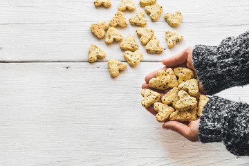 Fototapeta premium Homemade cookies with turmeric and flax seeds in the form of heart on white boards.