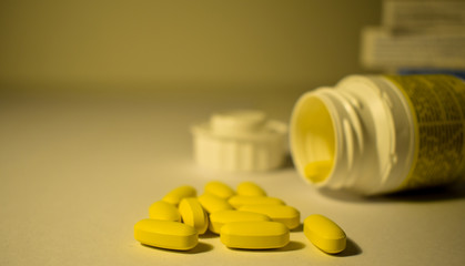 Yellow pills with a blurred boxes