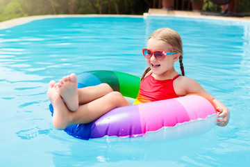 Child in swimming pool. Kids swim. Water play.