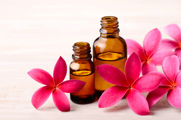 Plumeria Fragrance Oil Perfume and red plumeria flowers on the wooden table