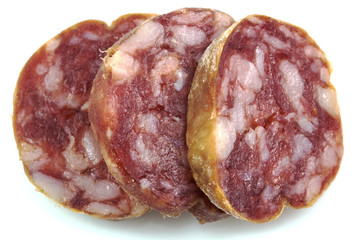 Top view macro detail of smoked salami slices, pepperoni slice, Italian prosciutto crudo ,raw ham texture isolated on white background , with clipping path.