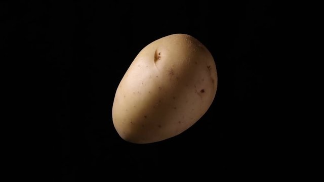 white potato rotating on black background