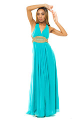 Naklejka premium Full body portrait of a beautiful young african woman in a turquoise dress
