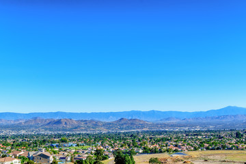 Fototapeta premium Urban homes stretch from mountain to mountain range in California