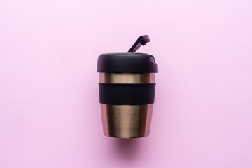 High angle view of reusable coffee cup on pink background