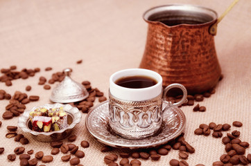 Obraz na płótnie Canvas Turkish Coffee and cezve coffee pot with turkish delight