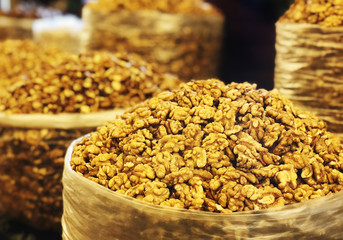 Close view of persian english common walnut in bag on showcase of local food market