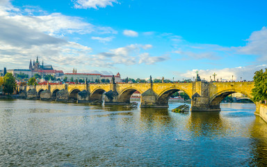 Prague Castle and Charles Bridge in Prague, in the Czech Republic at sunset. St. Vitus Cathedral. The Vltava River.