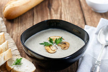 Mushroom cream soup on a wooden table.