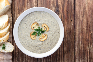Mushroom cream soup on a wooden table. Top view.