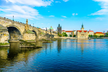 Obraz premium Charles Bridge in Prague in the Czech Republic. Old Town Bridge Tower. The Mill peninsula. Sculptures on the Charles Bridge. The Vltava River