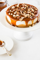 Homemade cheesecake with nuts and caramel sauce topping. Sweet cake at bakery restaurant.