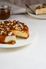 Homemade cheesecake with nuts and caramel sauce topping. Sweet cake at bakery restaurant.