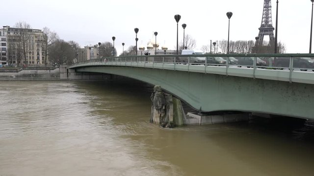 Paris,France-January 23, 2018: Paris people measure the risk of flood by monitoring which part of the statue the water reaches. Current warning level is not red.