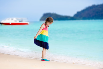 Kids on tropical beach. Children playing at sea.
